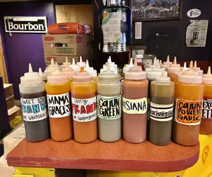 Hot sauce bottles lined up on a table